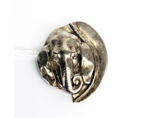 A heavy white metal (tested silver) elephant head brooch, H. 6cm.