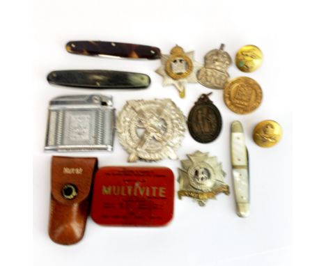 A small group of pen knives, lighter etc.
