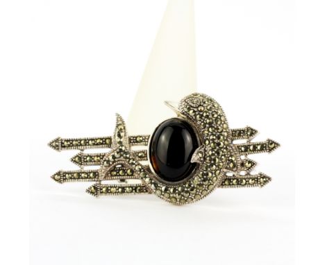 A large 925 silver dolphin brooch set with marcasite and an oval cabochon tourmaline, L. 6cm.