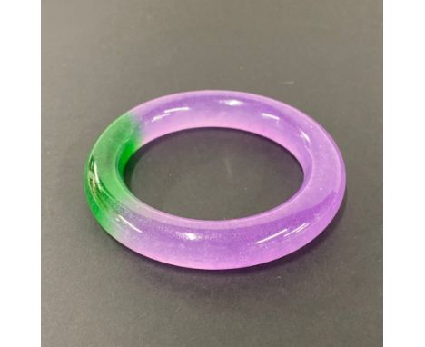 A lavender and green jade bangle, bangle W. 12mm, internal Dia. 5.6cm.