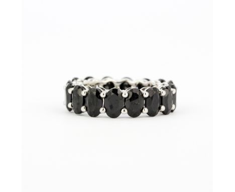 A 925 silver eternity ring set with oval cut black spinels, approx. 9.82ct total, (J). With certificate.