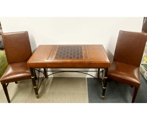 A lovely leather covered iron and brass framed chess and backgammon table, 111 x 73 x 55cm together with a pair of chairs.