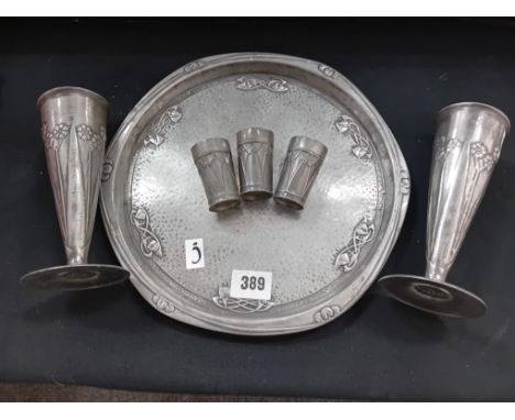 A LIBERTY EMBOSSED TRAY 10 INCHES DIAMETER TOGETHER WITH 2 ENGLISH PEWTER ART NOUVEAU VASES 6 INCHES HIGH 3 ART NOUVEAU BREAK