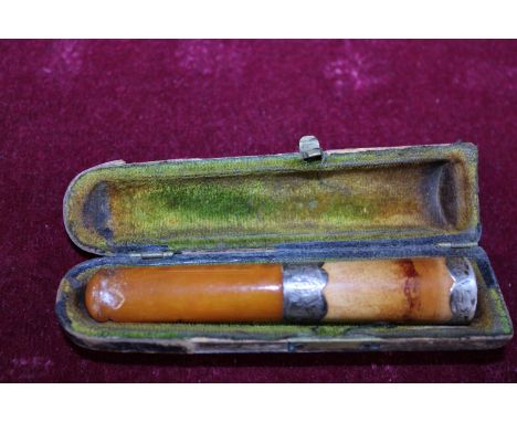 An antique cased amber and silver mount cheroot holder 