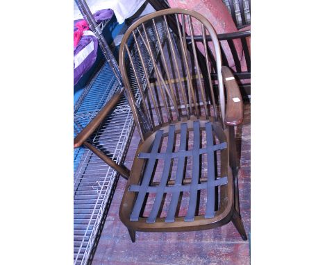 A vintage Ercol armchair. With spindle back.  Postage unavailable 