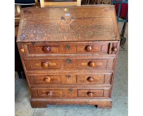 A 19th century oak bureau on bracket feet