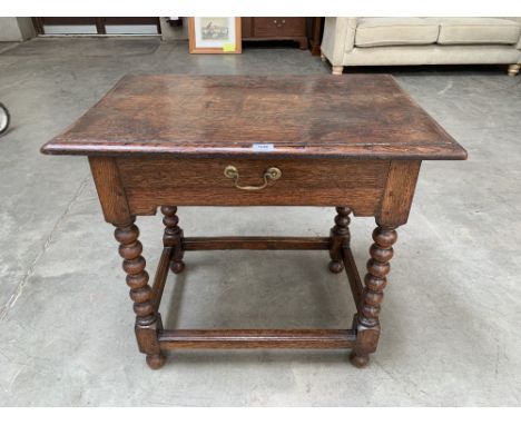 An 18th century joined oak side table with frieze drawer on bobbin turned legs with moulded perimeter stretchers. 31' wide