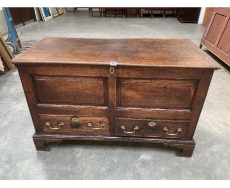 An 18th century joined oak dower chest, the cleated top over two fielded panels and conforming drawers, on bracket feet. 50' 