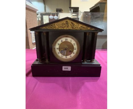 A French slate mantle clock with architectural case, the brass drum movement striking on a coiled gong. 10' high