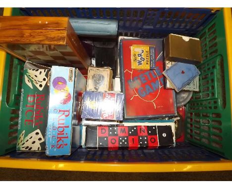A collection of boards games, playing cards. domino's, marbles, chess and other