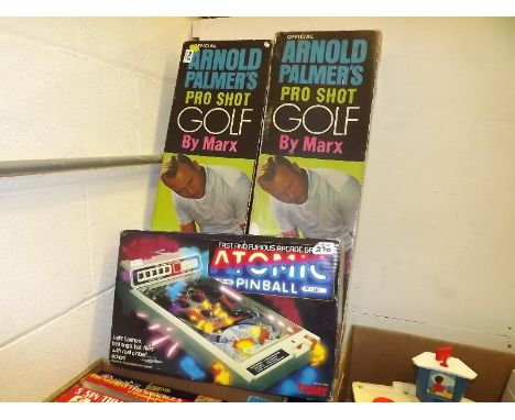 Two Official Arnold Palmer Pro-Shot golf games by Marx, boxed and a Tomy Atomic Table Top Electronic Pinball game, boxed