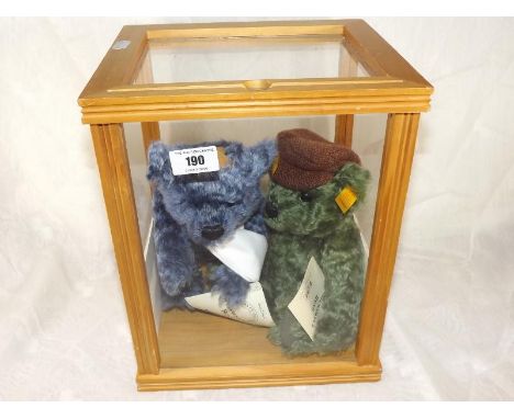 Steiff bears - a glazed display case containing two Steiff bears, Wednesday's Bear and Thursday`s Bear, each with button in e