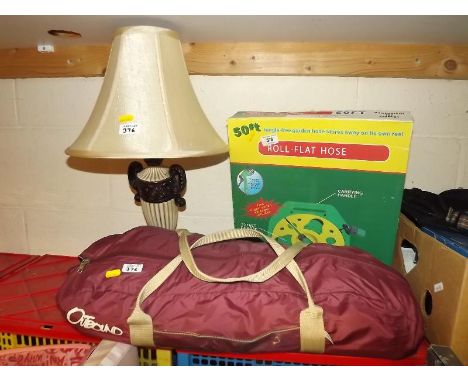 An Outbound camping tent, 50ft roll flat garden hose, and table lamp (3)