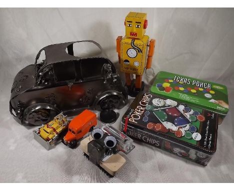 A box containing a tin-plate robot marked 'Lilliput', a novelty metal wine holder in the form of a VW Campervan, two tins of 