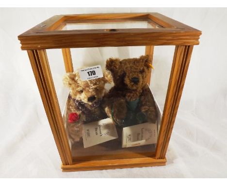 Steiff bears - a glazed display case containing two Steiff bears, Friday's Bear and Saturday`s Bear, each with button in ear,