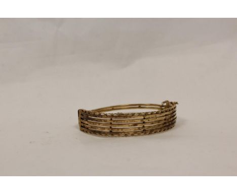 Gold hinged bangle of gate pattern. 12g 