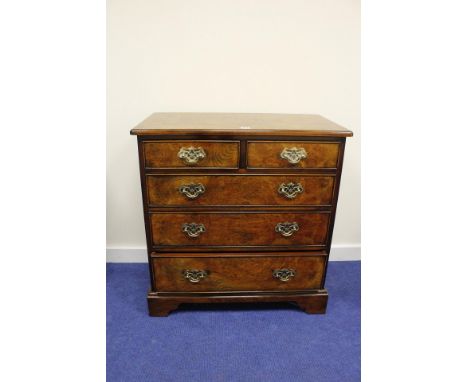Good small reproduction walnut chest of two short and three long drawers on bracket feet, 76cm wide. 