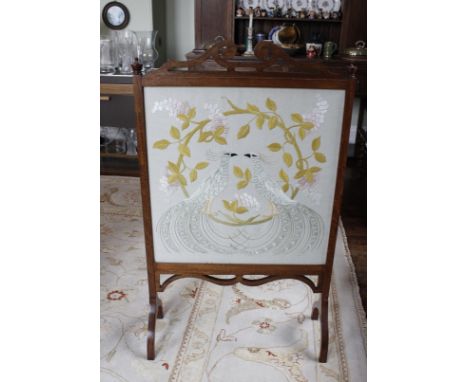 Early 20th century mahogany cheval firescreen, scrolling fretwork and silk panel of peacocks. 