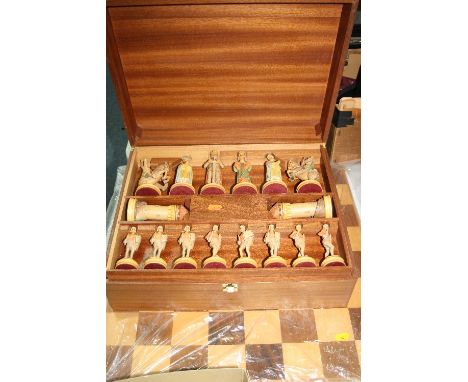 A SECOND HALF 20TH CENTURY ITALIAN CARVED AND PAINTED MAPLE WOOD MONTSALVAT (THE KNIGHTS OF THE ROUND TABLE) CHESS SET, by An