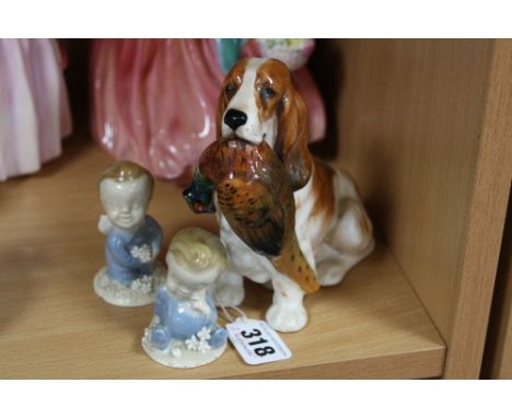 A ROYAL DOULTON FIGURE, Spaniel with Pheasant, HN1028, together with Wade 'Wynken' (chip to base) and 'Blynken', first versio