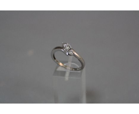 A 9CT THREE STONE DIAMOND CROSS OVER RING, ring size R, approximate size 3.0 grams