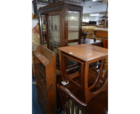 AN OAK LEAD GLAZED TWO DOOR BOOKCASE, (on an odd base), a G Plan nest of two tables, open bookcase, standard lamp and a rug (