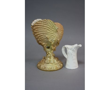 A ROYAL WORCESTER BLUSH IVORY NAUTILUS SHELL VASE, with gilt detailing, encrusted circular stem base, puce mark to base, heig