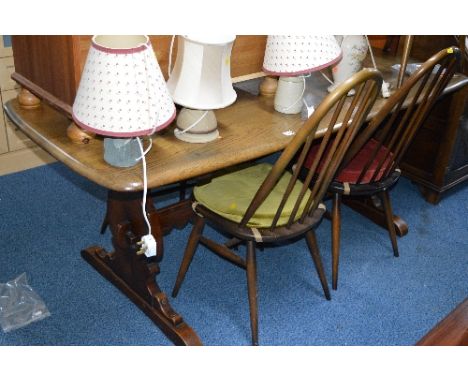 AN ERCOL STYLE REFECTORY TABLE, four spindle back chairs and two carvers (Ercol label to chairs) (7)