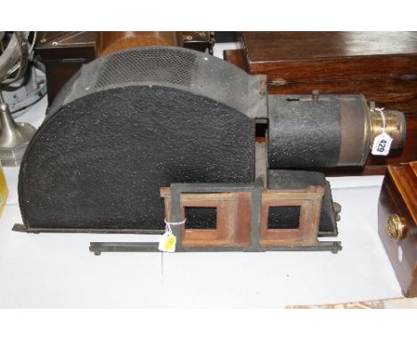 A MAGIC LANTERN, constructed from pressed steel and brass, with a double plate carriage, the body has textured paint finish a