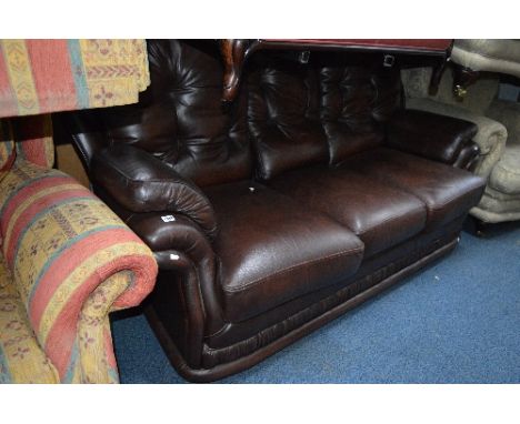 A BROWN LEATHER THREE SEATER SOFA
