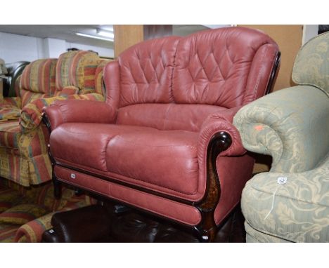 A LEATHER TWO SEATER SOFA, with dusky pink leather and wooden frame