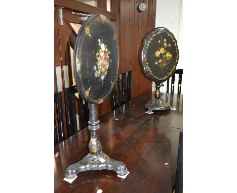 TWO VICTORIAN PAPIER MACHE TILT TOP TRIPOD TABLES, both black lacquered and painted and inlaid with a floral spray to the top