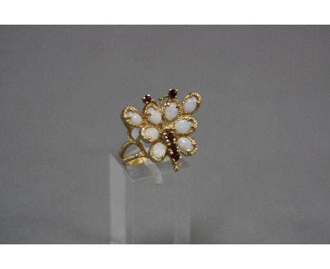 A MODERN GARNET AND OPAL DRESS RING, designed as a Butterfly, ring size R, stamped '14k', gross approximate weight 5.9 grams