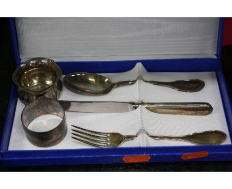 A GEORGE V SILVER CIRCULAR NAPKIN RING, Birmingham 1929, together with a boxed white metal child's knife, fork and spoon and 