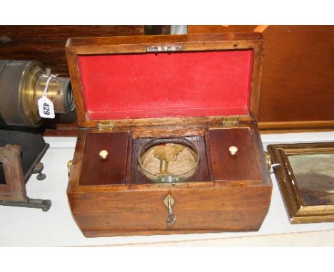 A WALNUT TEA CADDY, of Sarcopagus shape, fitted interior to include glass bowl, with brass handles, length approximately 29cm