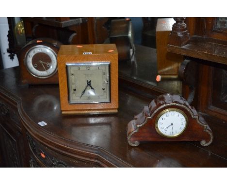 A LIGHT OAK ART DECO MANTLE CLOCK, signed The Goldsmiths & Silversmiths Co Ltd, another oak mantle clock and a mahogany mantl