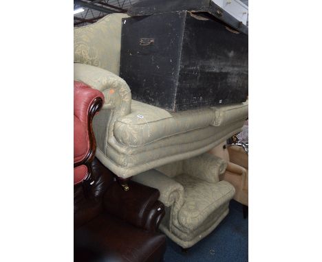 AN UPHOLSTERED TWO PIECE LOUNGE SUITE, comprising of a three seater sofa and an armchair with green floral upholstery