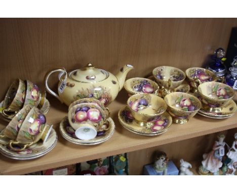 AYNSLEY 'ORCHARD GOLD' TEAWARES, with classic fruit decoration, various signatures 'N.Brunt' and 'D.Jones', to include teapot