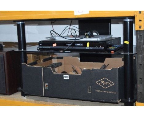 A BLACK GLASS TV STAND, and a Panasonic DVD recorder (remote)