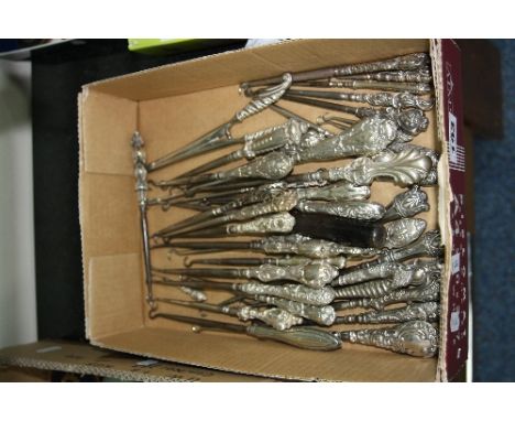 FORTY SILVER HANDLED BUTTON HOOKS AND A PAIR OF SILVER HANDLED GLOVE STRETCHERS, one button hook with teddy bear handle, make