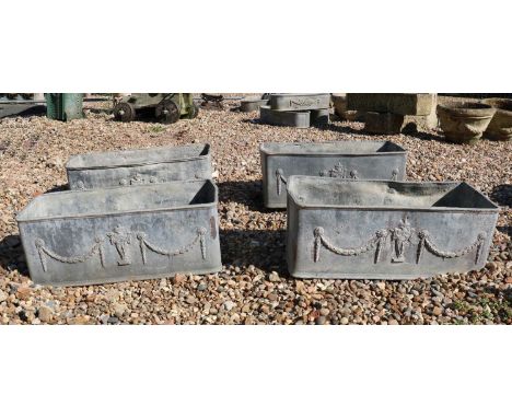 A set of four lead trough planters,20th century, in the Neoclassical taste, with urn and draping swags,67cm wide,27cm deep,75