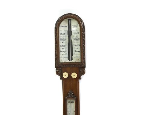 A Victorian mahogany stick barometer, the rounded top with a carved scroll border, enclosing an ivory register and inscribed 