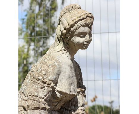 A reconstituted stone garden font,with a figure of a lady, above a basin, raised on a plinth,120cm diameter154cm highConditio