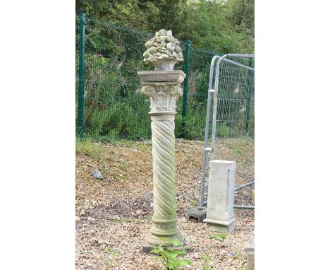 A composite stone Neoclassical style column,with wrythen moulded decoration,150cm high,together with a finial,modelled as a b