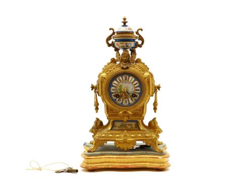 A French gilt metal and porcelain mantel clock,the urn finial leading to a blue circular dial inscribed 'Marshall &amp; Sons,