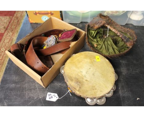 Antique armadillo basket, tambourine, leather utility belt and a Western light meter