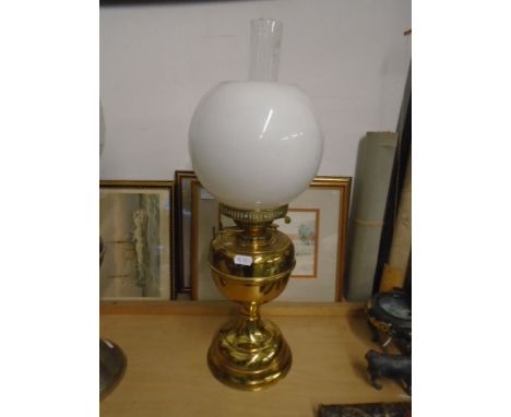 Brass base oil lamp with white globe shade