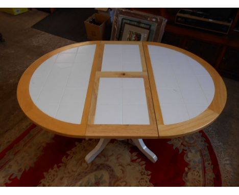 Extending tile topped pine pedestal table W107cm (145cm when extended} One broken tile.