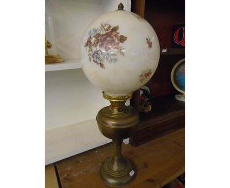 brass base oil lamp with floral decorative globe shade