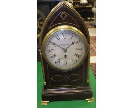 A 19th Century mahogany and brass inlaid mantel clock of lancet form, the movement with circular silvered dial inscribed "Han